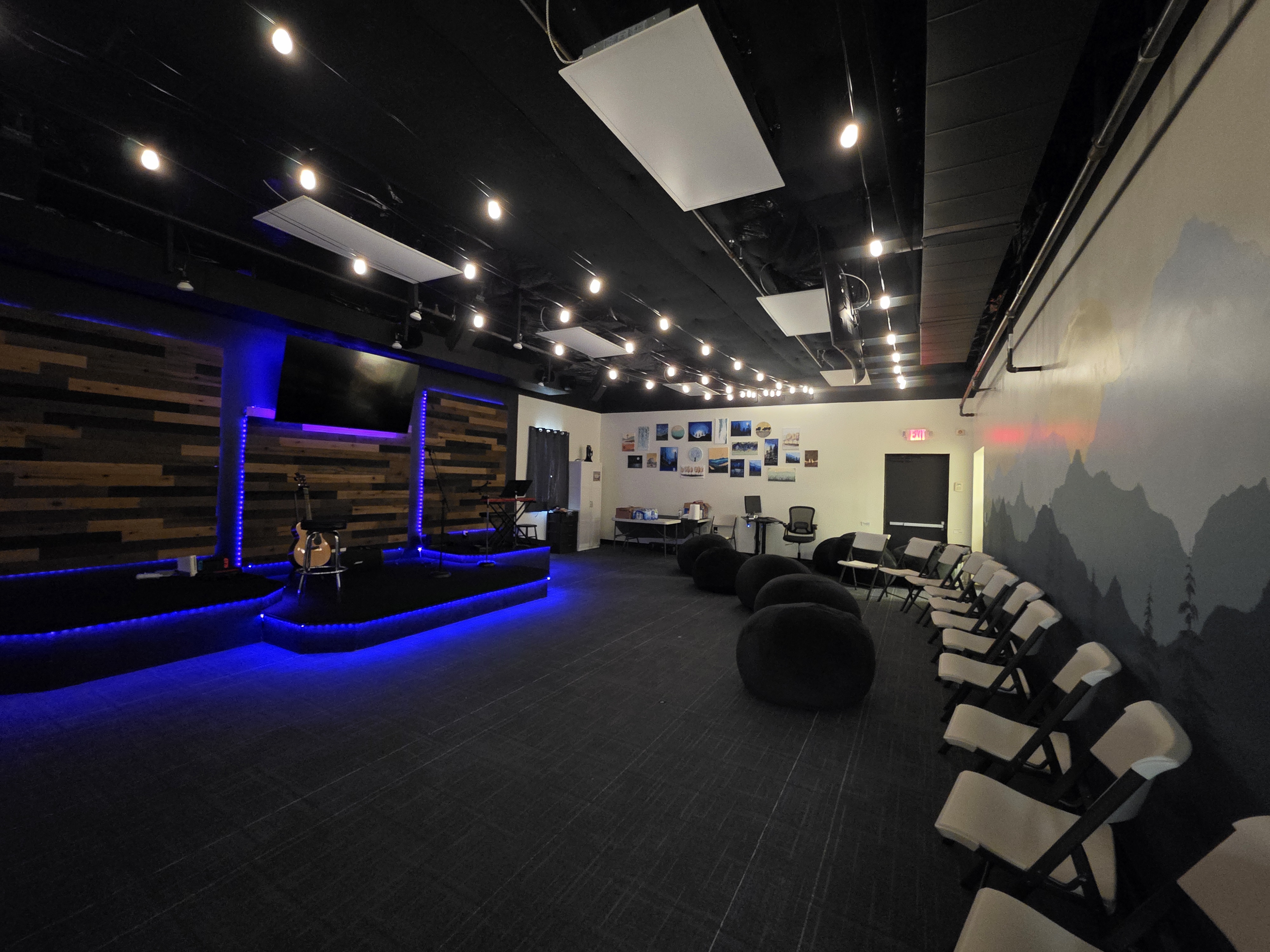 Gateway Youth room with a worship stage, seating, and blue accent lighting