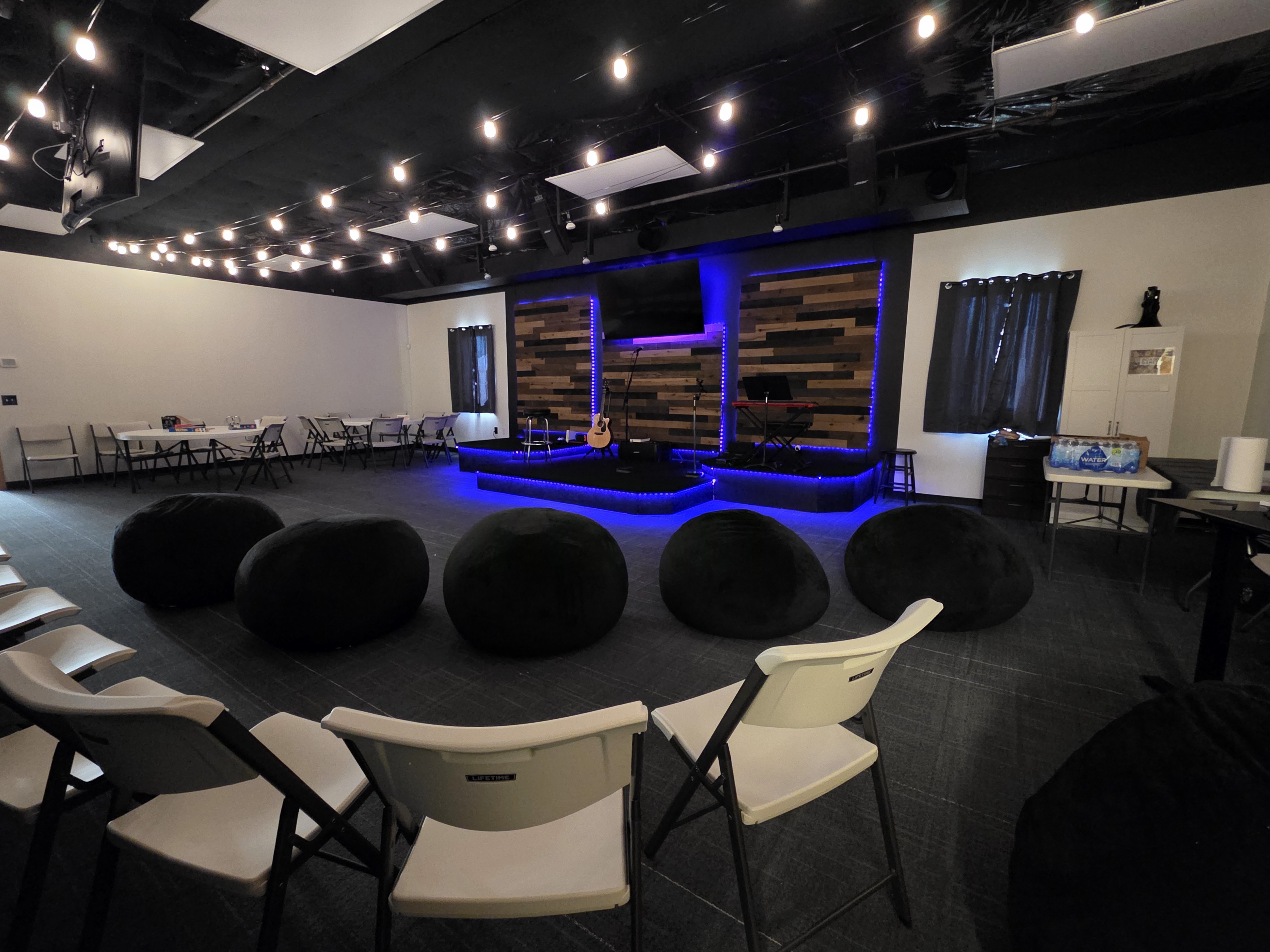 Gateway Youth room with beanbag seating, tables, and worship stage